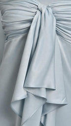 Close-up detail of the bodice bow and satin ruffles