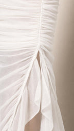 Close-up detail of side slit and mesh ruching on White dress