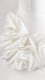 Close-up of dimensional fabric rosette texture on white fabric