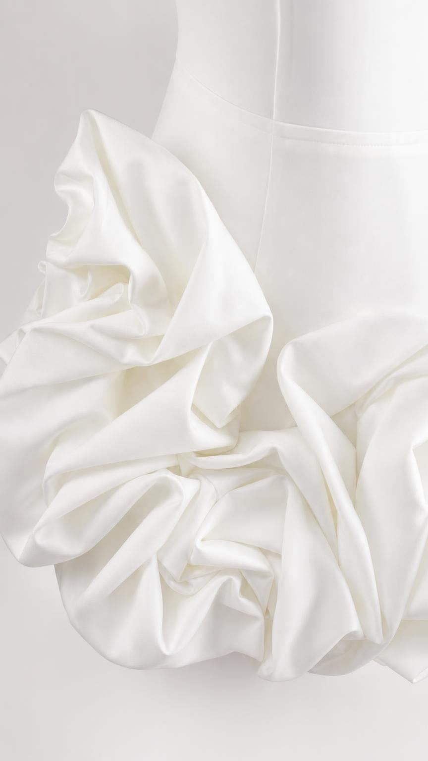 Close-up of dimensional fabric rosette texture on white fabric