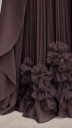 Close-up of pleated skirt and dimensional ruffled hem details