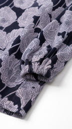 Close-up detail of the sleeve cuff and textured fabric pattern
