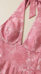 Close-up detail of the pink floral jacquard fabric and V-neckline