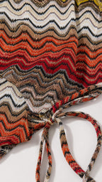 Close-up detail of the multi-color textured chevron knit fabric and tie closure