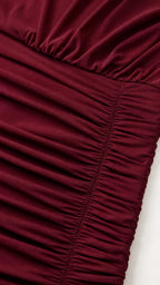 Close-up of texture and ruching detail on burgundy fabric