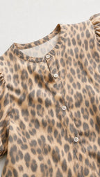 Close-up detail of button-up top collar and fabric pattern