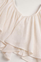 Close-up detail of soft fabric and ruffle trim