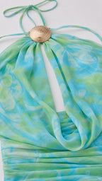 Close-up detail of metal hardware and cowl neckline