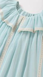 Close-up of lace trim and ruffles on light blue dress