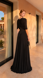 Back view of black elegant maxi gown with draped upper overlay and pleated skirt