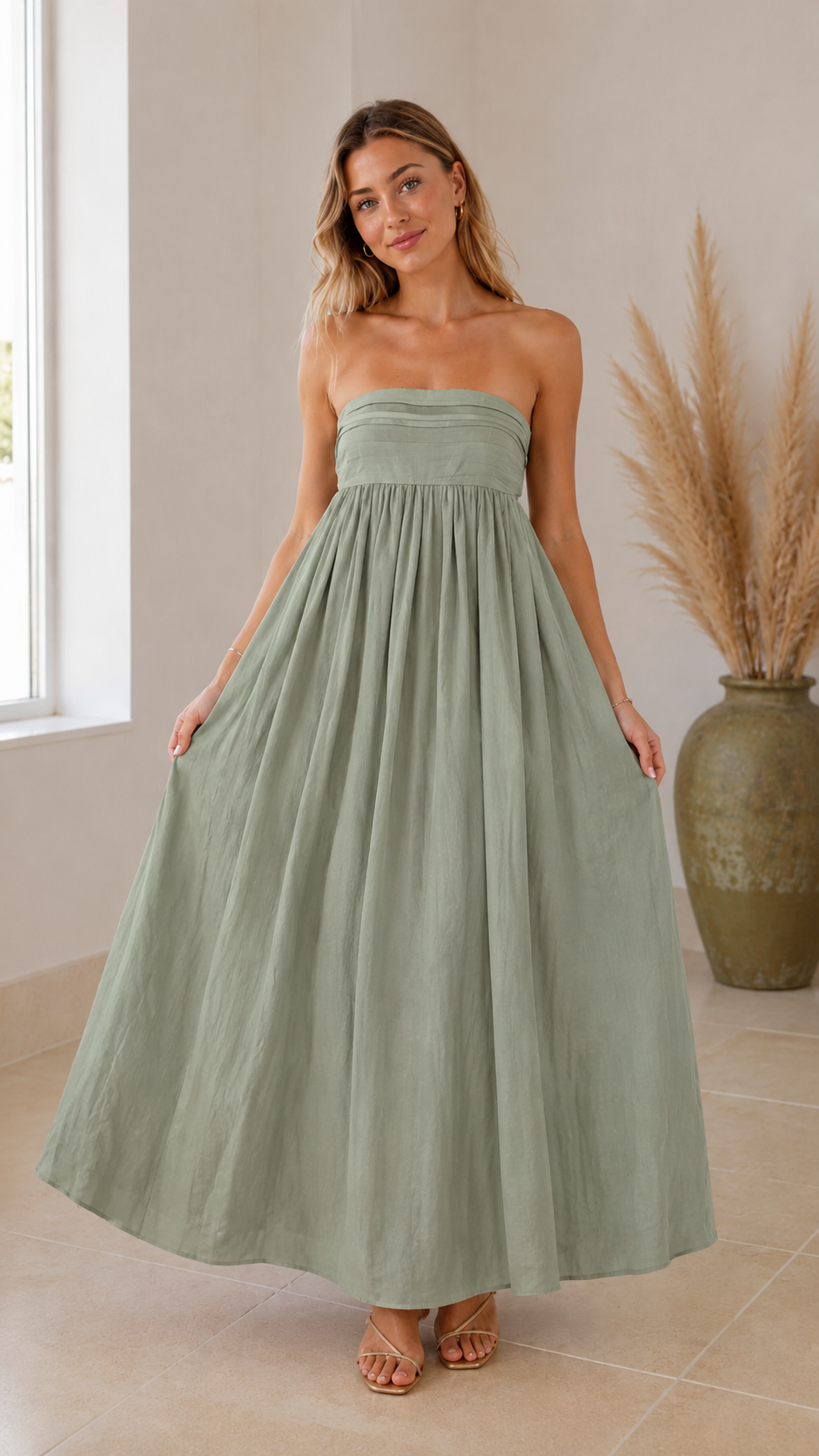 Front view of sage green strapless maxi dress with full gathered skirt
