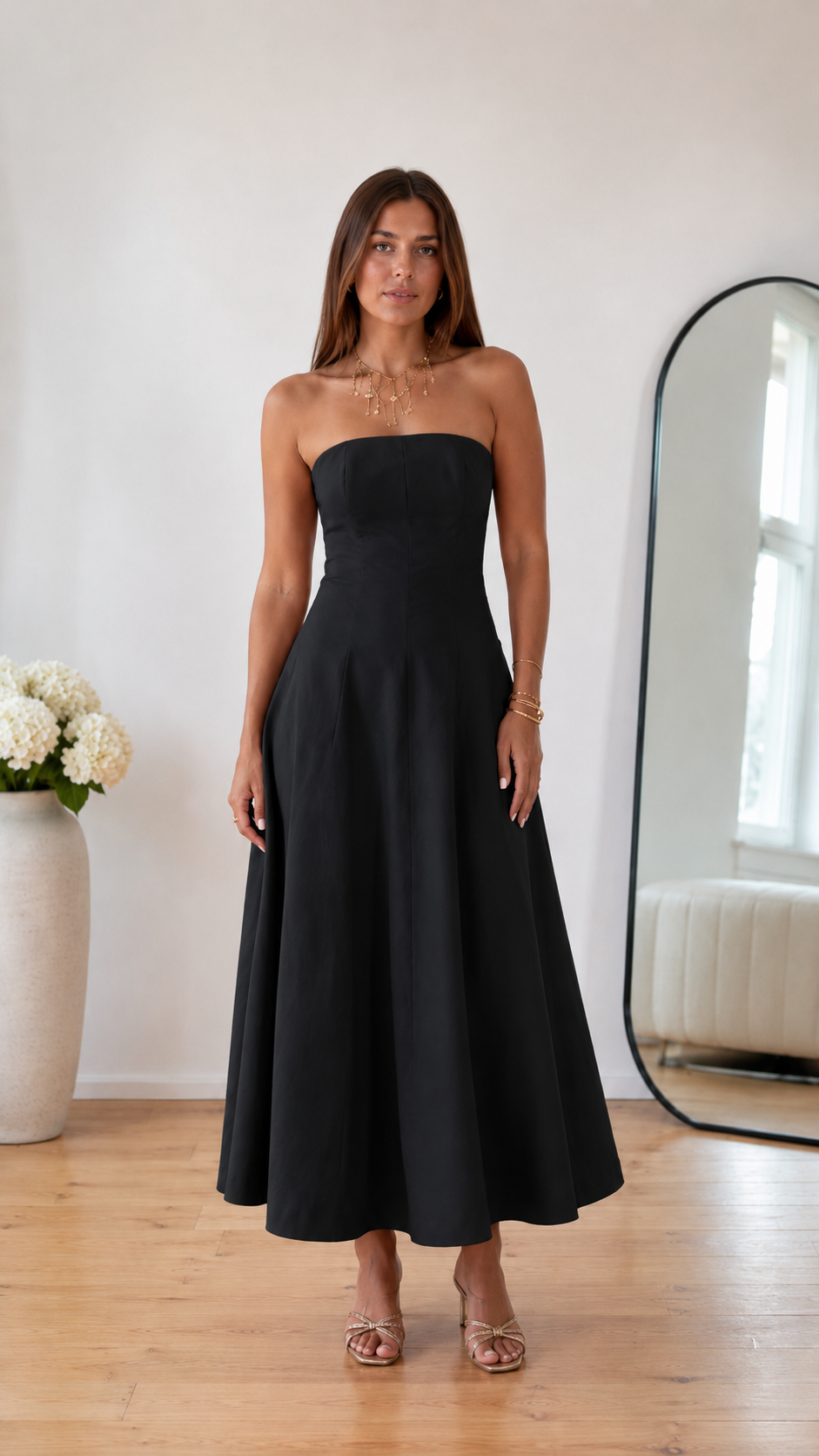 Front view of black strapless A-line midi dress