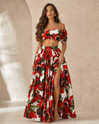 Woman wearing a red floral off shoulder two piece skirt set front view
