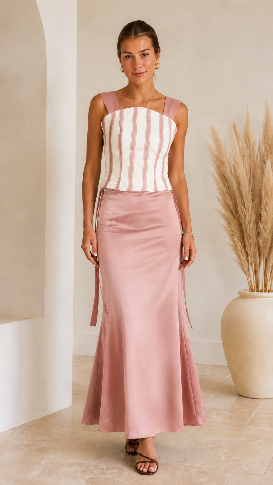 Front view of blush pink striped corset maxi dress with satin-look skirt