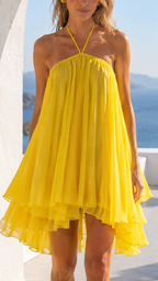 Close-up of yellow gathered halter neckline and chiffon-like drape