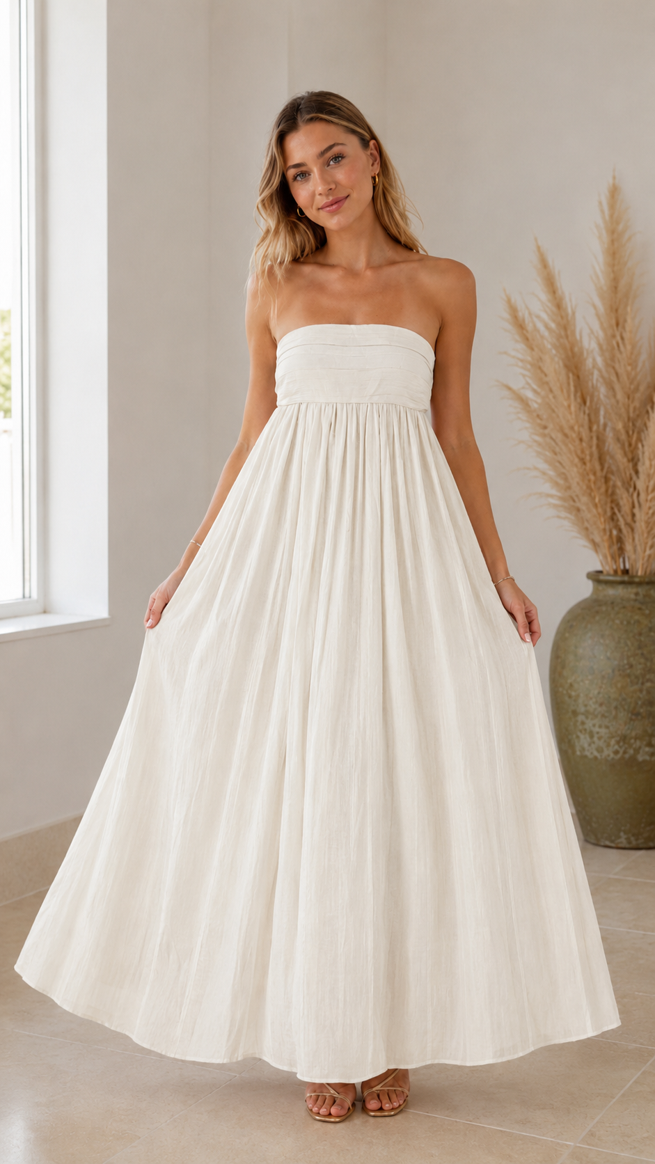 Front view of ivory strapless maxi dress with soft textured finish and maxi length