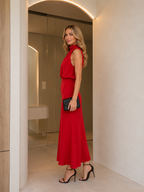 Side view of red sleeveless draped cowl neck midi dress