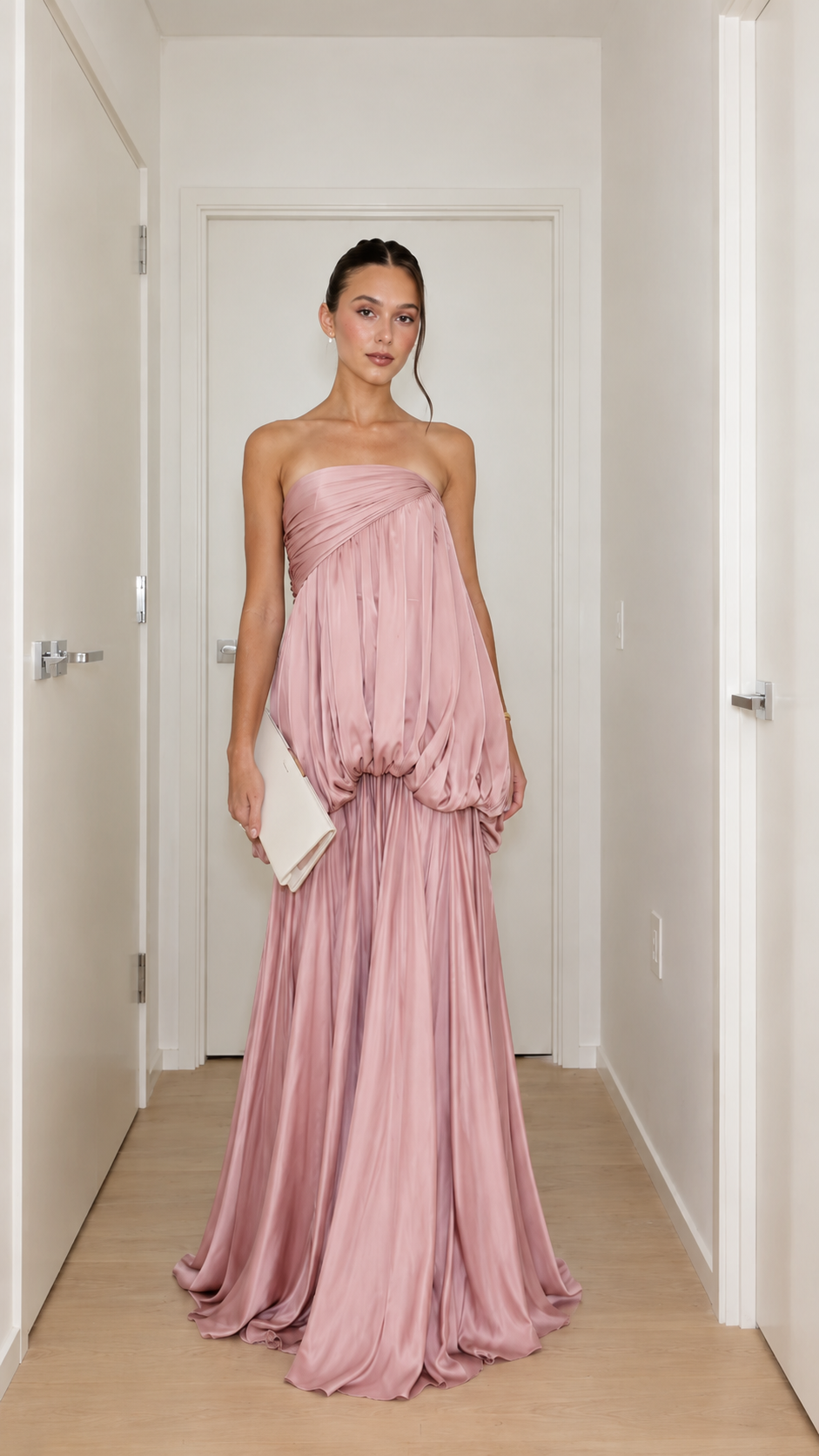 Front view of dusty pink strapless draped bubble waist maxi gown
