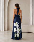 Back view of navy halter maxi dress with open back and neck tie