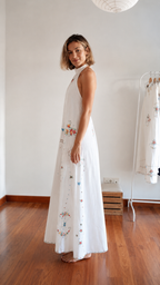 Side view of white embroidered halter maxi dress