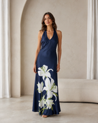 Front view of navy floral halter maxi dress in maxi length